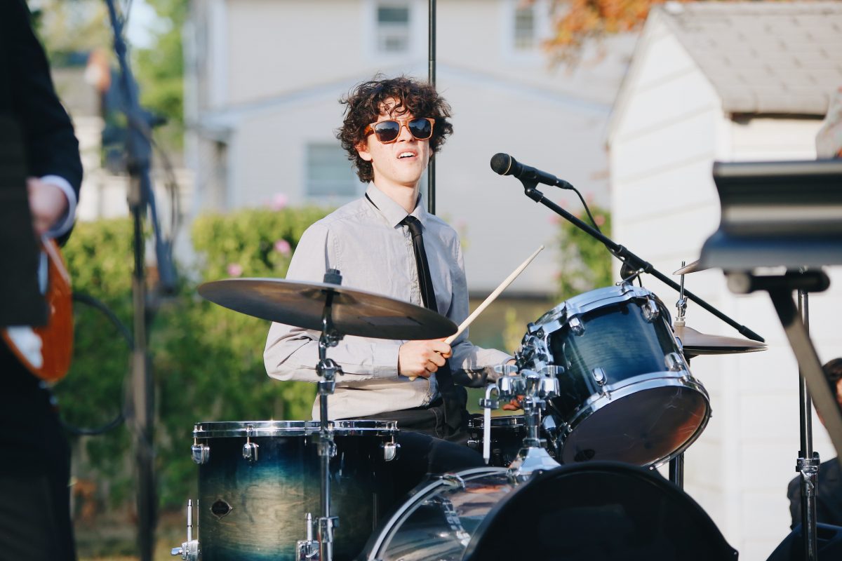 Boy playing drums in the street. Representing drum lessons at SFE music school